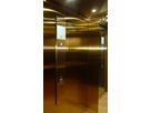 Lift cabin with gold-coloured Oro HL stainless steel walls and integrated display