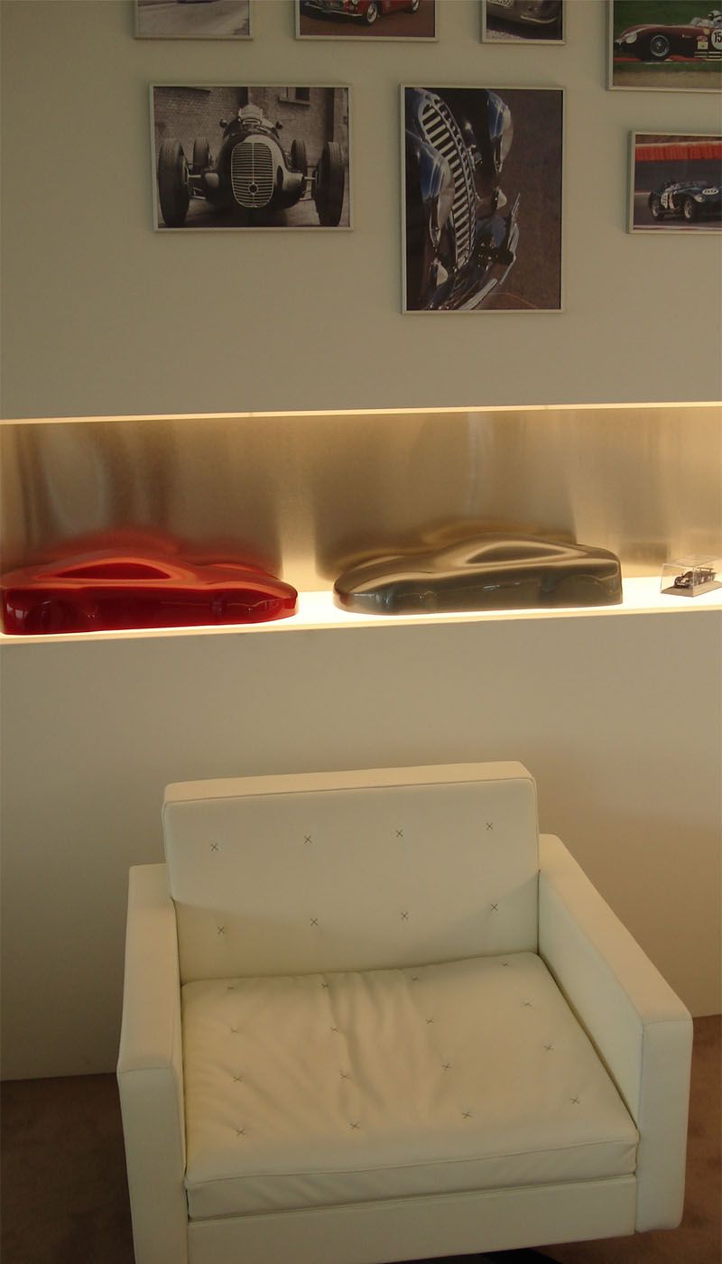 White armchair in front of illuminated Champagne SB stainless steel wall niche