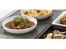 Bowls with hot dishes on ribbed stainless steel warming plate in display