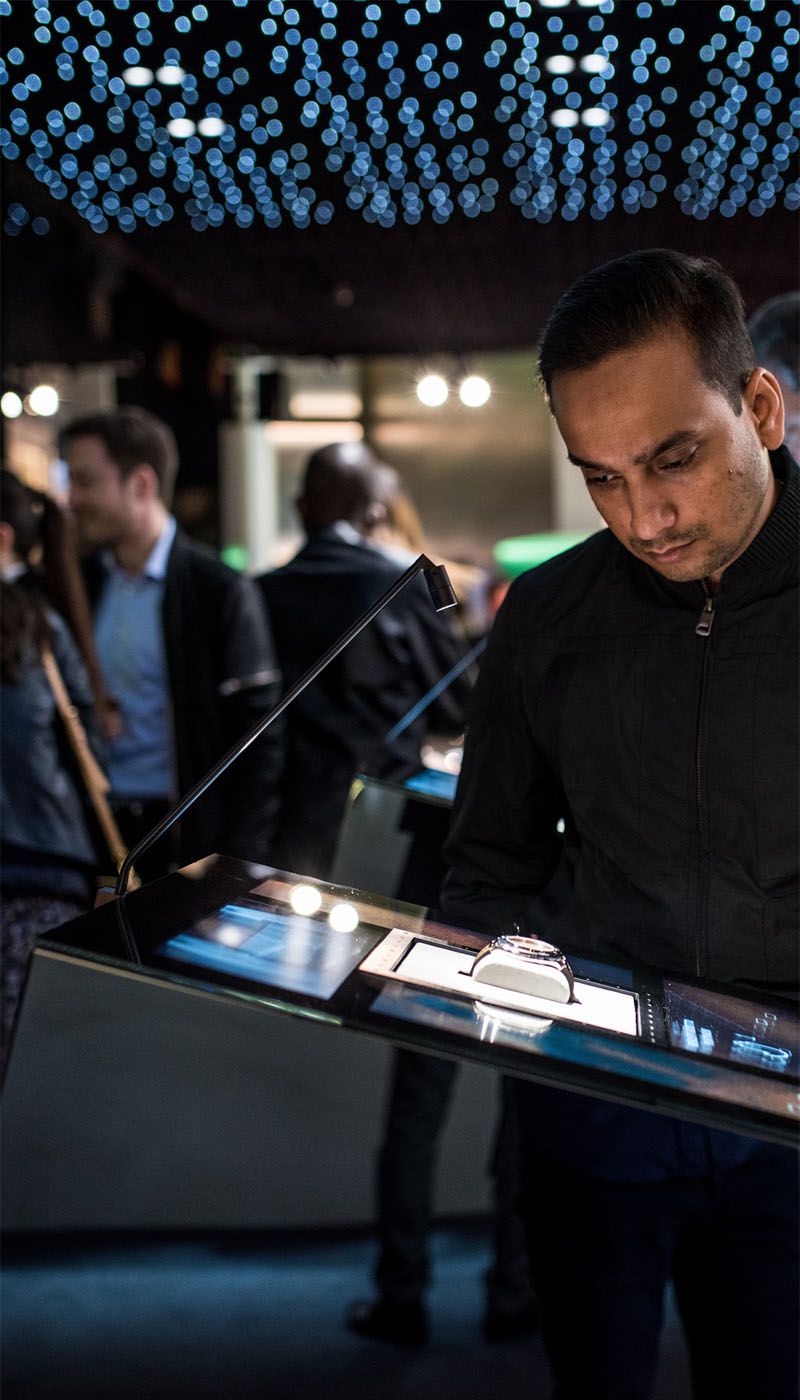 Visitor interacting with Hublot watch display made of Nero SM stainless steel